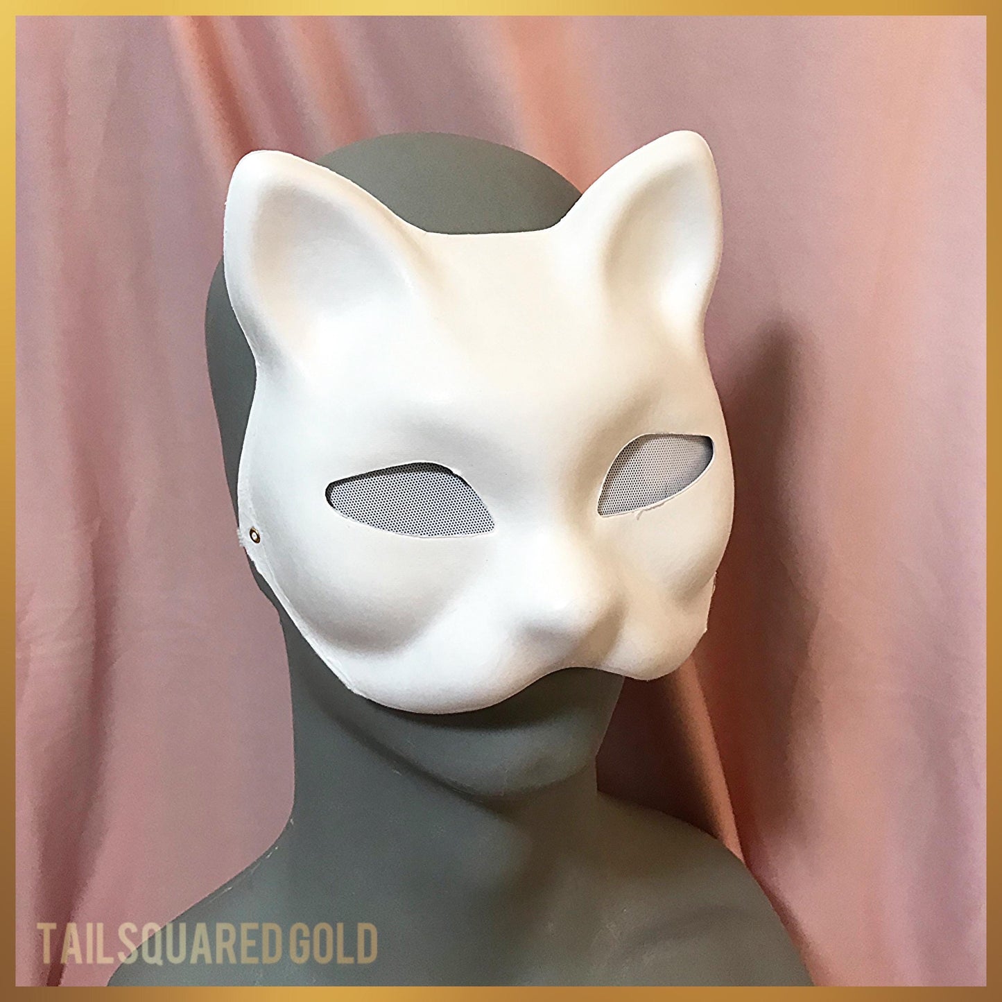 White cat mask on a mannequin head with a pink curtain background