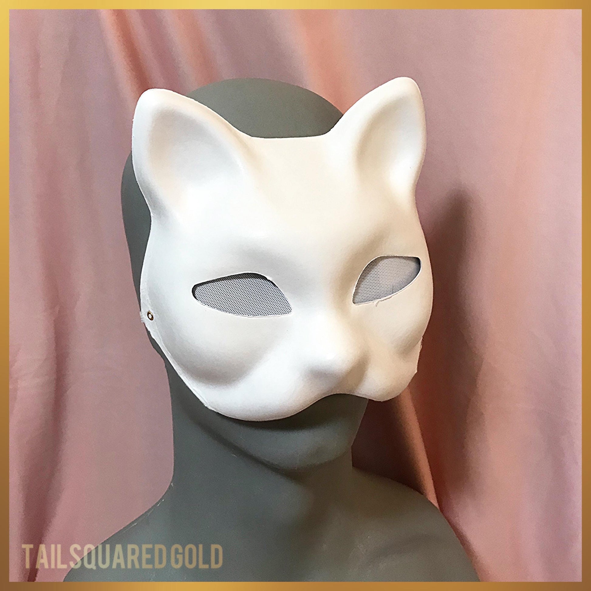 White cat mask on a mannequin head with a pink curtain background